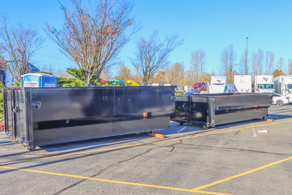 Professional dumpster rental service with roll-off container on residential driveway in Amsterdam